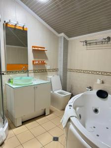 a bathroom with a tub and a toilet and a sink at Arba Hotel in Samarkand +43 photos