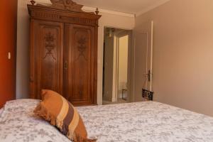 a bedroom with a bed and a wooden cabinet at Appartement dans maison de campagne lumineuse in Orange +7 photos