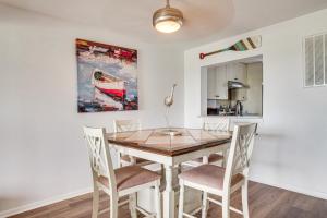 a dining room with a table and chairs at Harbor Island Condo w/ Pool Access: Walk to Beach! in Oceanmarsh Subdivision