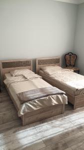 two beds sitting next to each other in a bedroom at Lux in Gyumri