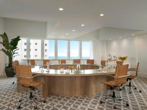 a meeting room with a large table and chairs at Grand Beach Hotel in Miami Beach