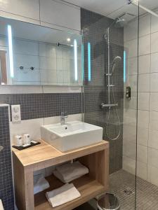 a bathroom with a sink and a shower at Le Sterenn in Saint-Guénolé