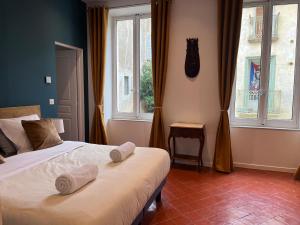 Postel nebo postele na pokoji v ubytování Abri du vent, chambres et appartements