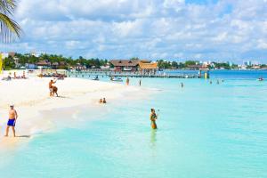 a group of people in the water on a beach at Beachscape Kin Ha Villas & Suites in Cancún