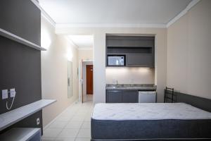 Postel nebo postele na pokoji v ubytování Estudio no Centro de Floripa