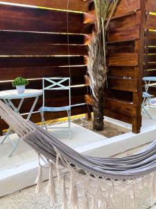 a hammock on a patio next to a table at La Jamaca in La Parguera