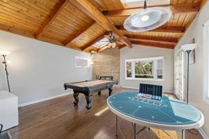 a room with a ping pong table and a ceiling at Urban Oasis - Chic Design - Game room/Movie room in Skokie