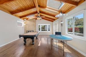 a room with a pool table and a ceiling at Urban Oasis - Chic Design - Game room/Movie room in Skokie