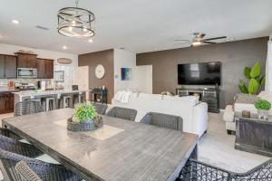 a kitchen and living room with a table and chairs at Disney Area Vacation Rental with Game Room and Pool! in Davenport