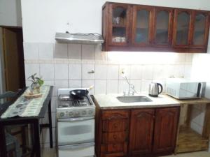 a kitchen with a stove and a sink at La Soñada in Malargüe