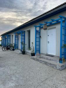 a row of blue doors on a building at VadooInn in Vadu