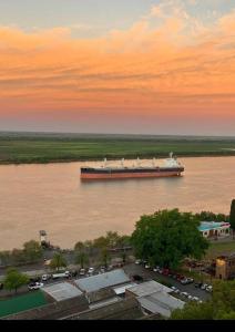 a large ship on the water at sunset at Ushuaia 1 in Rosario