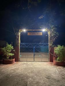 a gate with a sign that reads the ranger house at night at The Mango Woods Cottage with Bathtub in Alibag with Swimming Pool in Alibag