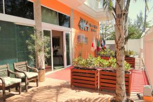 a patio with chairs and a tree in front of a building at KS Beach Hotel in Rio de Janeiro