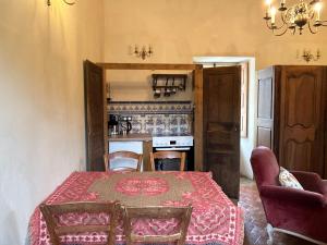 a room with a table and chairs and a kitchen at La Buffonnerie in Moutiers-Saint-Jean +47 photos