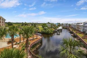 a view of a river with palm trees and buildings at Waterside Village Condo 302 by Pristine Properties Vacation Rentals in Mexico Beach