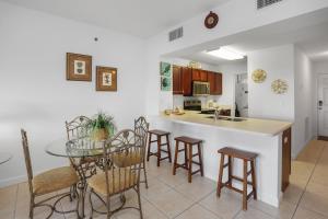 a kitchen and dining room with a table and chairs at Waterside Village Condo 302 in Mexico Beach