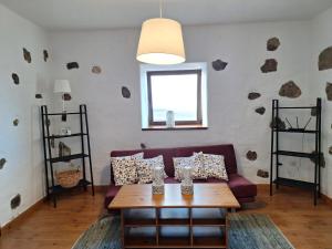 a living room with a couch and a table at Casa el Gallo in Teguise