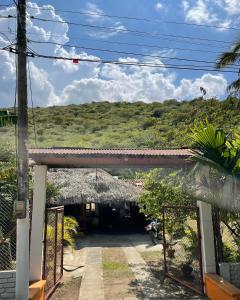 an entrance to a building with a grass roof at Ancestral Casa de Campo in Roldanillo