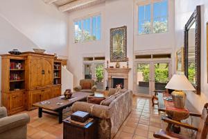 a living room with a couch and a fireplace at Quail run in Santa Fe