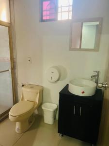 a bathroom with a toilet and a sink at Access Blue Cristal in Monterrey