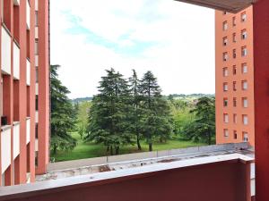a view of a park from between two buildings at Appartamento donatello in Imola