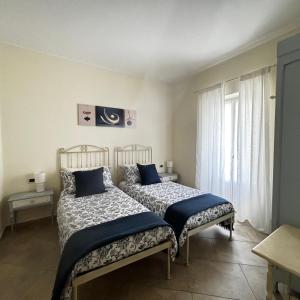 - une chambre avec 2 lits et une fenêtre dans l'établissement Il sogno di Jo a 50 mt dal mare, à Borgio Verezzi