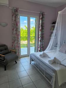a bedroom with a bed and a chair and a window at Rosegarden in Sami