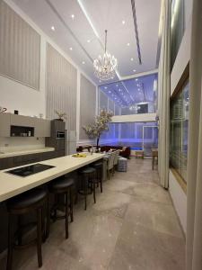 a kitchen with tables and chairs and a large window at شاليه كادي cady resort in Al Khobar