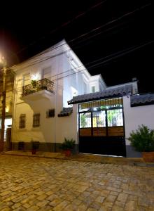 a white house with a garage at night at Vila Emre in Korçë +30 photos
