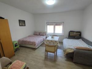 a living room with two beds and a couch at Cozy hotel with breakfast in Subotica