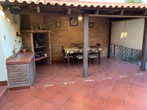 a patio with a table and a brick wall at Apartamento con jardin in Cochabamba