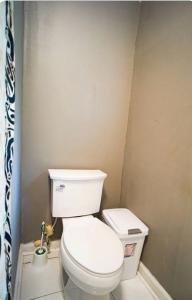 a bathroom with a white toilet in a room at Hilltop Hideaway in Atlanta