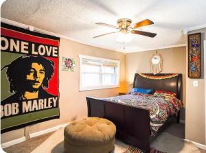 a bedroom with a bed with a poster of obama at Hilltop Hideaway in Atlanta