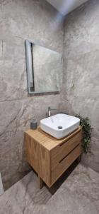 a bathroom with a sink and a mirror at Апартамент ТАНЯ Top center location and free parking in Kazanlŭk