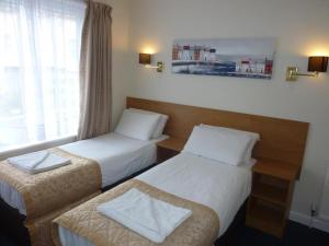 Postel nebo postele na pokoji v ubytování Serenity Hotel