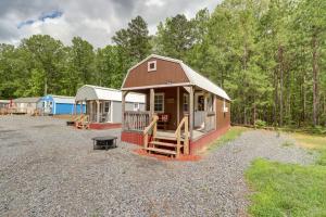 a small cabin with a porch and a bench in a yard at Tree-Lined Higden Retreat Close to Parks and Trails in Fairfield Bay