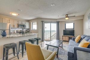 a living room with a couch and a table and a kitchen at Mod Myrtle Beach Resort Condo with Beach Access in Myrtle Beach