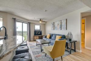 a living room with a couch and a table at Mod Myrtle Beach Resort Condo with Beach Access in Myrtle Beach