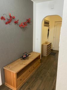a room with a wooden table and red birds on the wall at Fewo Burgwald in Industriehof