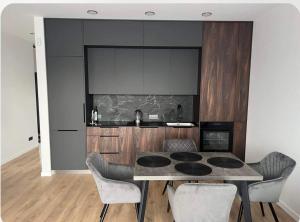 a kitchen with a table and chairs in a room at Holiday Apartments in Klaipėda