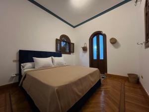 a bedroom with a bed and a window and a door at pyramids view Guest villa in Al Mazghūnah