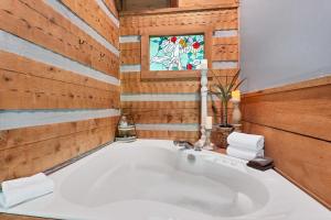 a large white tub in a bathroom with a window at A View for Two in Townsend
