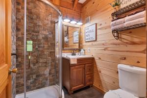 a bathroom with a shower and a toilet and a sink at A View for Two in Townsend