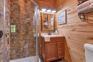 a bathroom with a shower and a sink and a toilet at A View for Two in Townsend +22 photos
