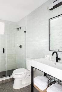 a bathroom with a toilet and a sink and a shower at The Richard, The Edgartown Collection in Edgartown