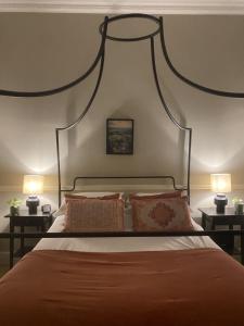 a bedroom with a large bed with two lamps at The Beeches - Chatsworth Apartment No 2 - Sleeps 4 in Baslow