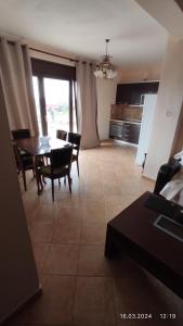 Una cocina y un comedor con mesa y sillas. en Kallithea Eco-Village, en Kallithea Halkidikis