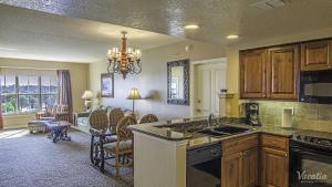 a kitchen with a counter and a living room at Hilton Grand Vacation Club Tuscany Village in Orlando