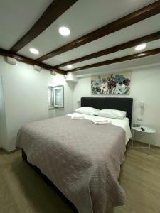 a bedroom with a large bed and a table at Apartman Mama Marija in Dubrovnik